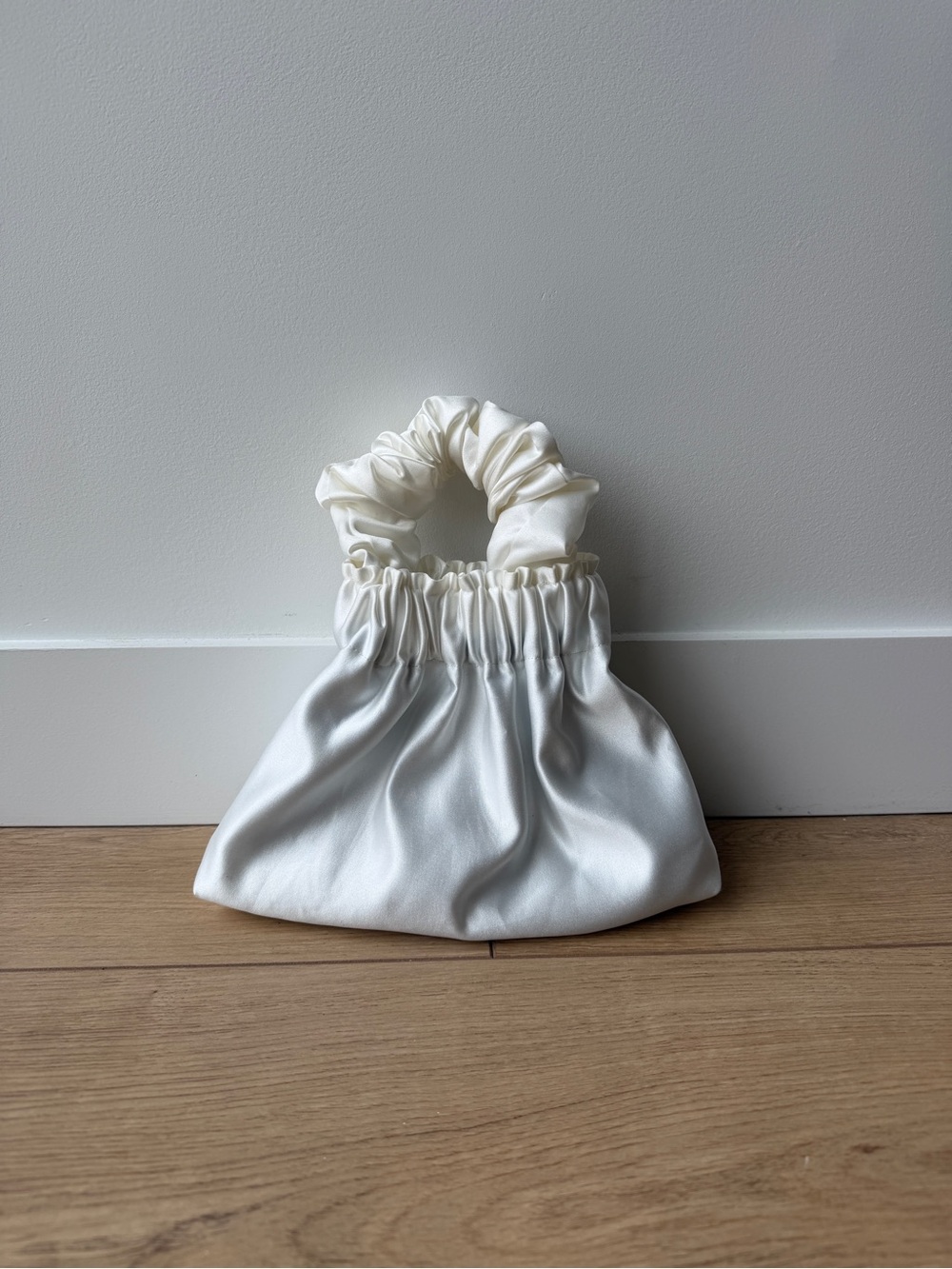 A Bronze Age Satin Scrunch Handle Clutch in White